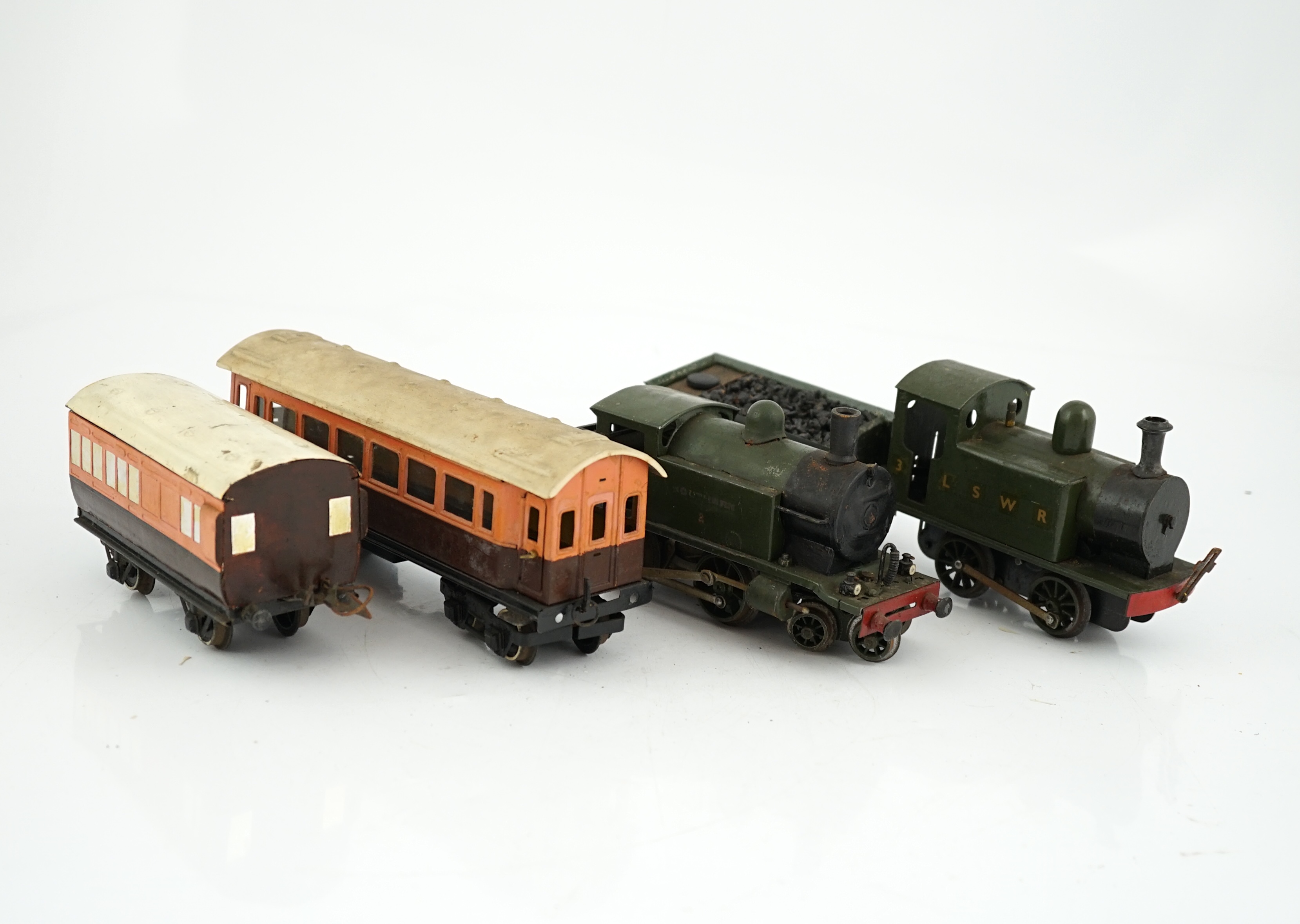 Fifteen tinplate 0 gauge railway items, including three clockwork locomotives; an LSWR 0-4-2 tender loco, an LSWR 0-4-0T and a SR 4-4-0T, all built using some commercial parts with some elements scratch built